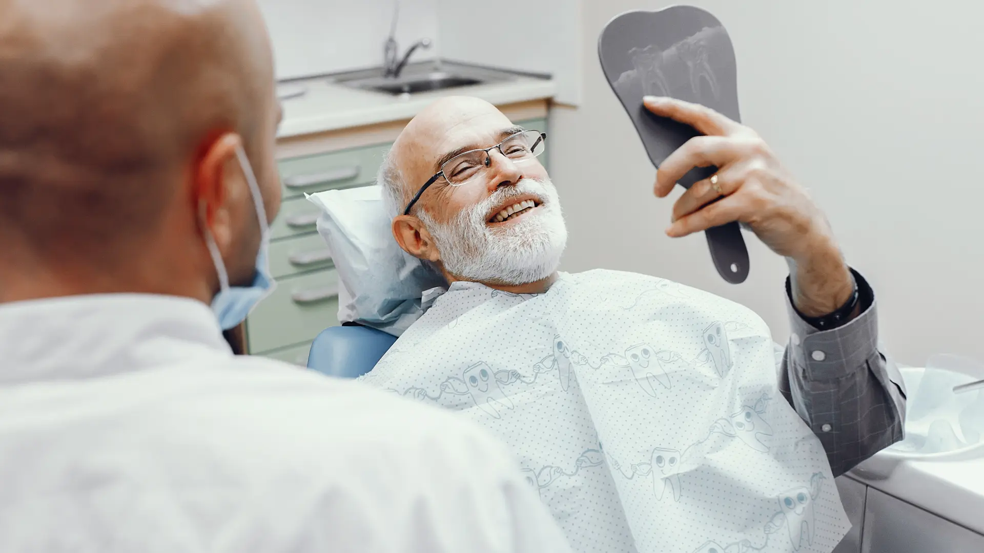 Patient checking smile in the mirror